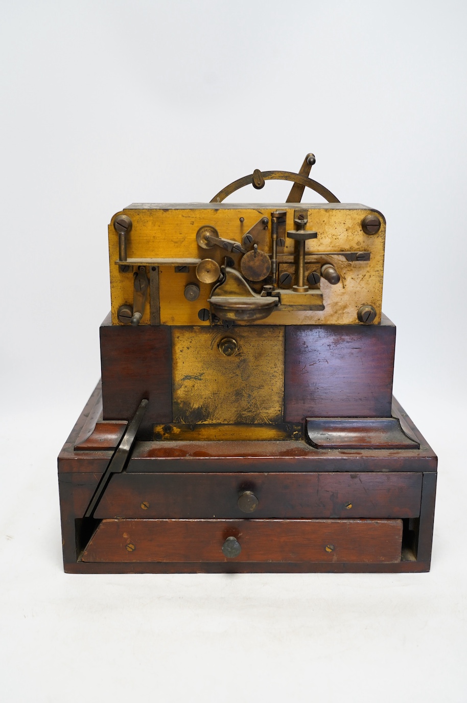 A late 19th century brass and mahogany Wheatstone type telegraph receiver (Morse inker), containing two drawers with paper rolls, 30cm high, 30cm wide, 28cm deep.